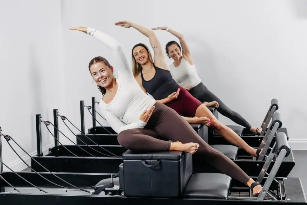 Studio Pilates reformer class with custom reformer machines
